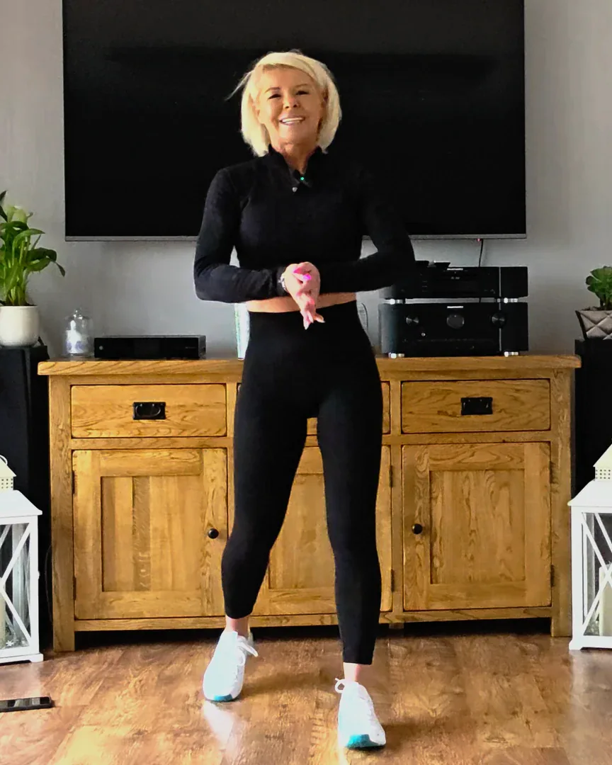 Anna smiling in her living room